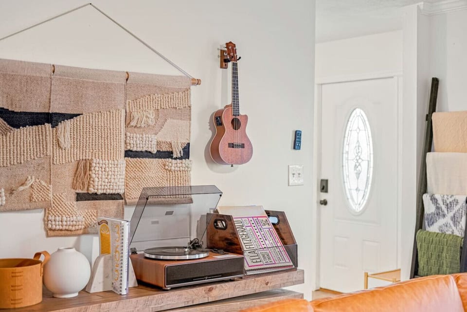 Enjoy the bohemian charm in our newly renovated home, with designer touches like a record player and unique wall decor, adding a special touch to your stay.