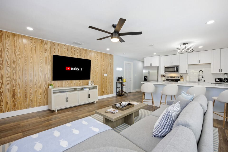 Cocoa Beach Living Room | Breezy coastal retreat with wood accents, sectional seating, and relaxed modern style.