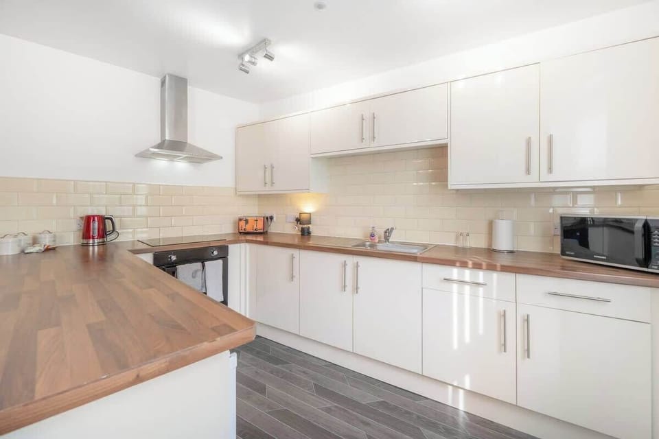Family-friendly kitchen oasis equipped with all essentials, including a washer & dryer, oven, fridge and full cookware set. Plus, thoughtful touches like children's dinnerware ensure everyone feels right at home in this cozy culinary haven.