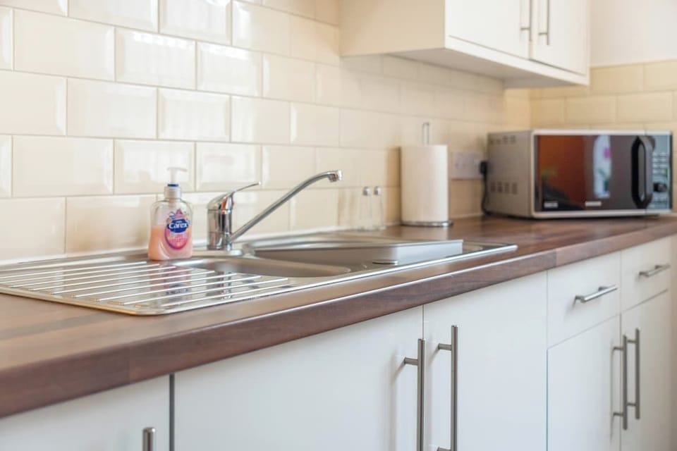 Family-friendly kitchen oasis equipped with all essentials, including a washer & dryer, oven, fridge and full cookware set. Plus, thoughtful touches like children's dinnerware ensure everyone feels right at home in this cozy culinary haven.