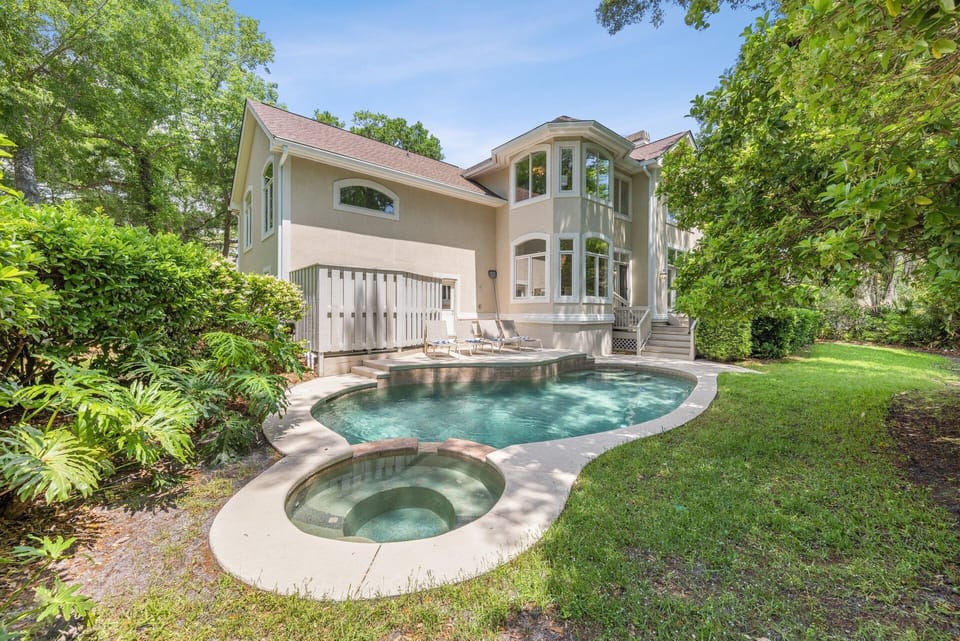 The highlight of this home is its private yard. At its heart lies a pool and splash-down spa, perfect for unwinding or fun water activities.