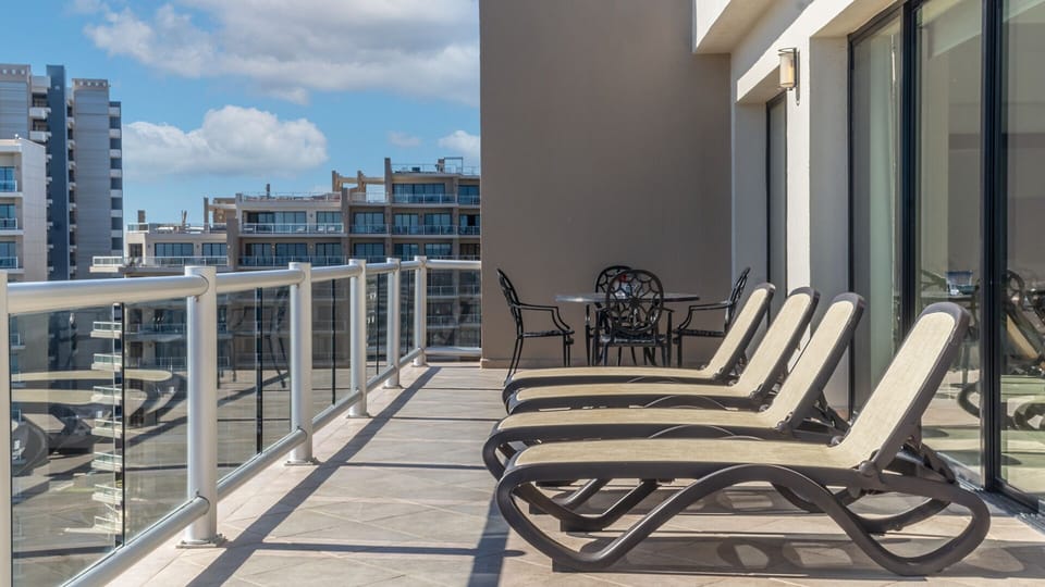 lots of chaise lounge chairs on the balcony