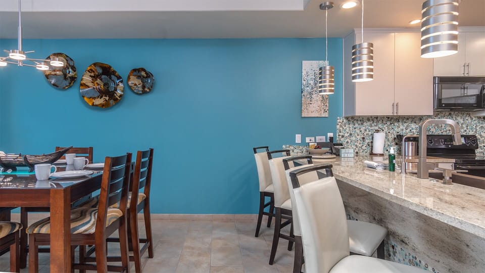 the dining table is next to the kitchen counter