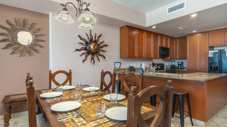 The dining table next to the kitchen counter.
