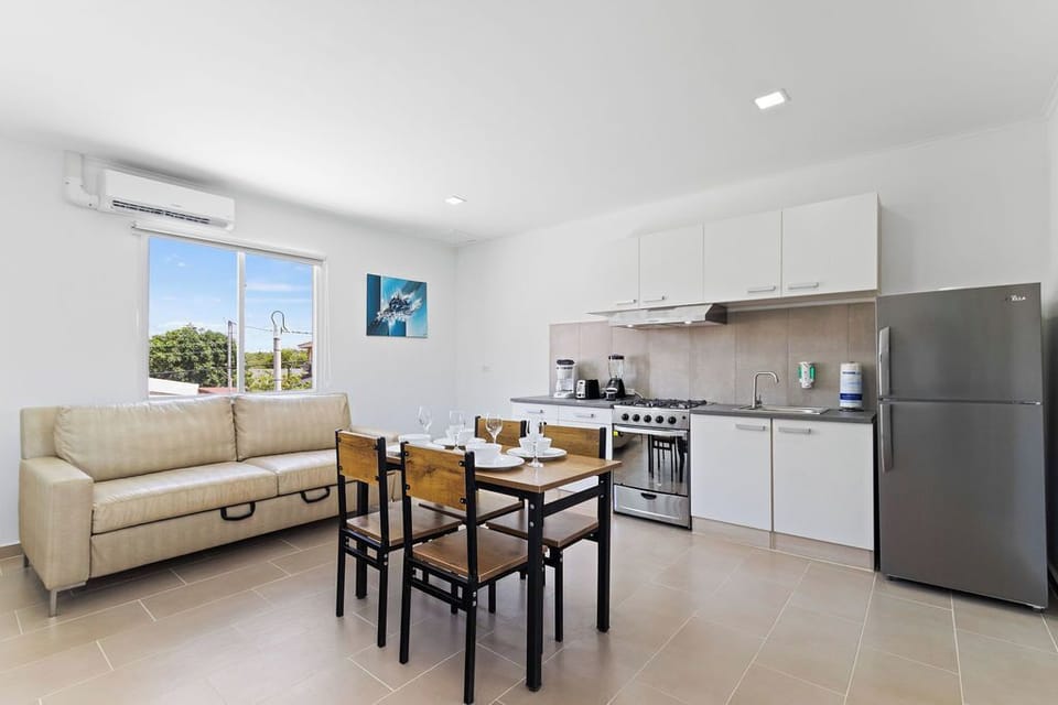 Our dining and living area features a plush sofa where you can sink in and unwind after a day of exploration, creating the perfect space to relax and recharge.