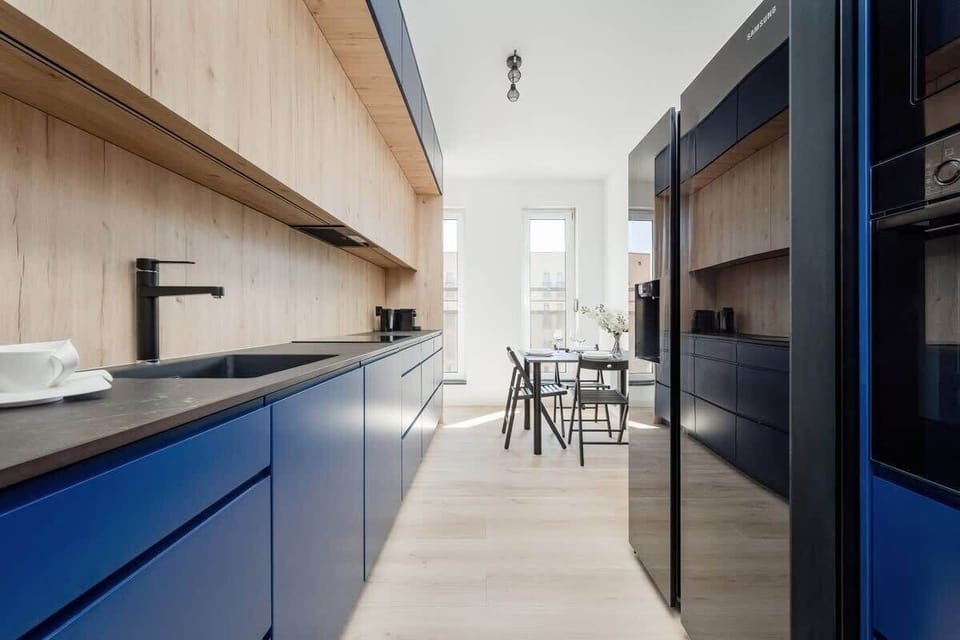 Separate kitchen with dining table and chairs.