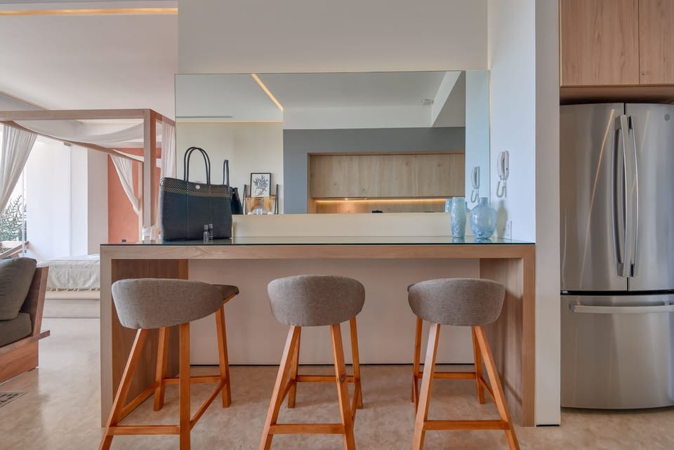 Fully-stocked, modern kitchen with breakfast counter that doubles as an additional workspace with easy access to a variety of power outlets.