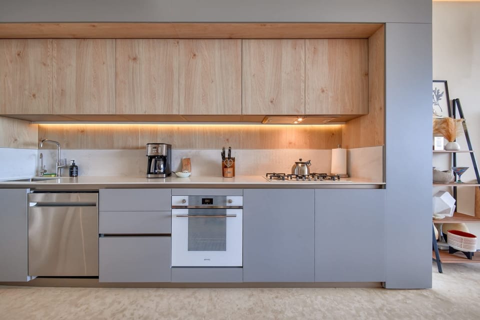 Fully-stocked, modern kitchen with breakfast counter that doubles as an additional workspace with easy access to a variety of power outlets.