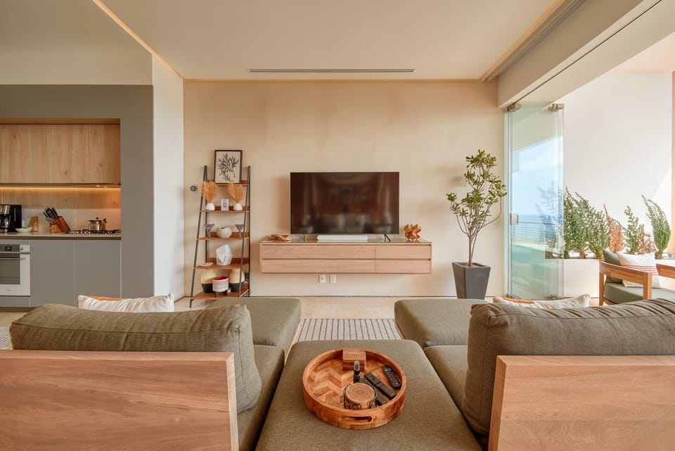 Sleek, floating entertainment center made of solid Amapas wood, with a 65 inch, brand new Samsung TV and Bluetooth-enabled sound bar.