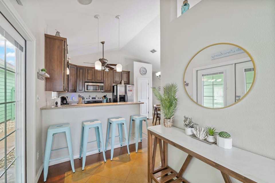 Gather with friends at your stylish breakfast bar, surrounded by coastal touches and warm wood finishes that make meal prep a joy.