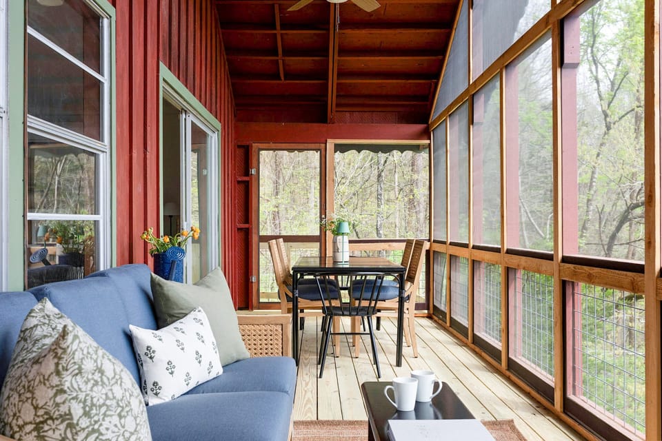 Spacious screened porch looks out to our private back yard with mountain view