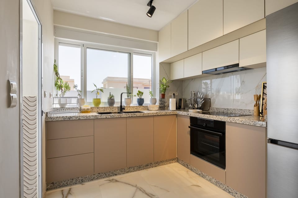 This modern kitchen features stainless steel appliances and granite countertops, perfect for preparing delicious meals during your stay.