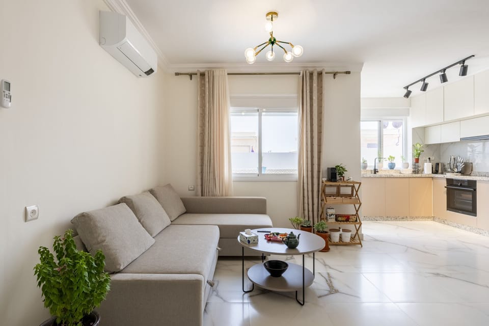 In the heart of the apartment, this inviting sofa creates a cozy spot to relax, read, or enjoy a conversation.