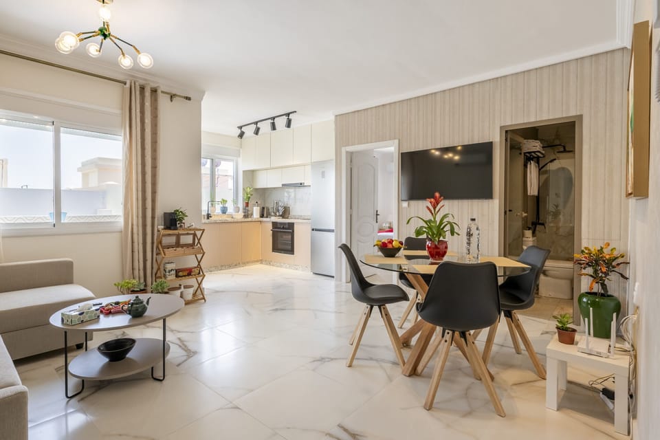 This spacious living room seamlessly integrates with a dining area, perfect for entertaining guests or relaxing in a sociable open space.