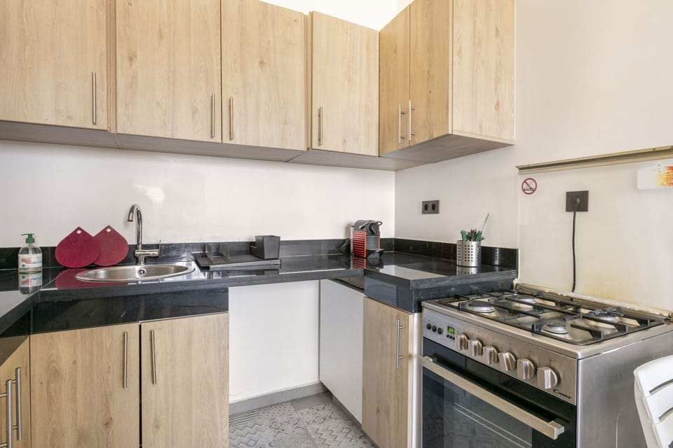 His well-equipped kitchen features a dishwasher for convenient cleanup, a stove for cooking meals, and a sink for washing dishes.
