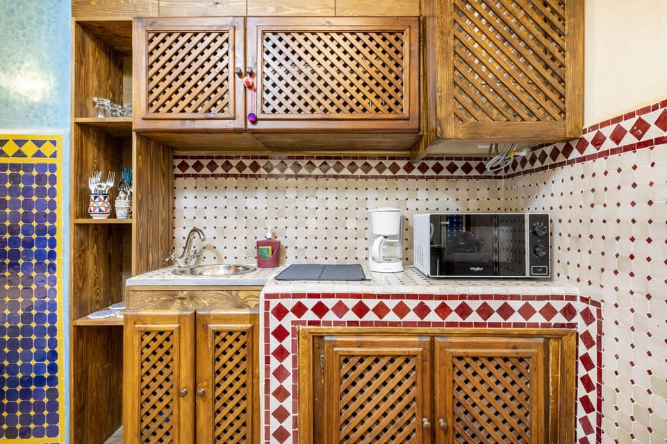 Well-equipped kitchenette with a sink, microwave, and coffee maker, perfect for preparing light meals and beverages during your stay.