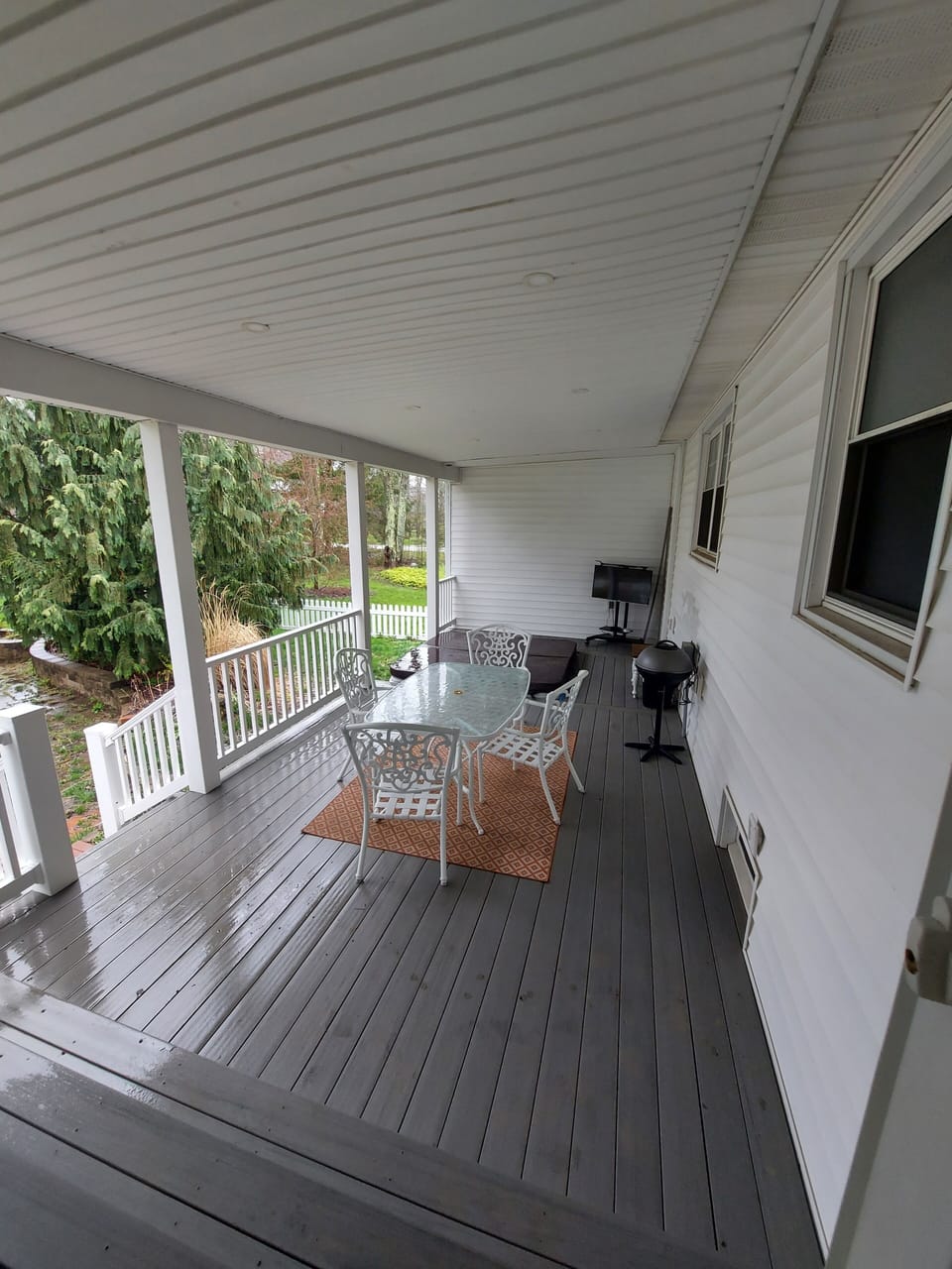 The deck is built around the hot tub.It is a covered deck. Hot tub is covered.