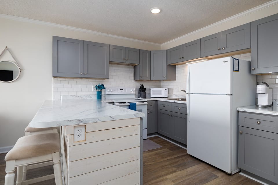 Spacious kitchen with bartop seating