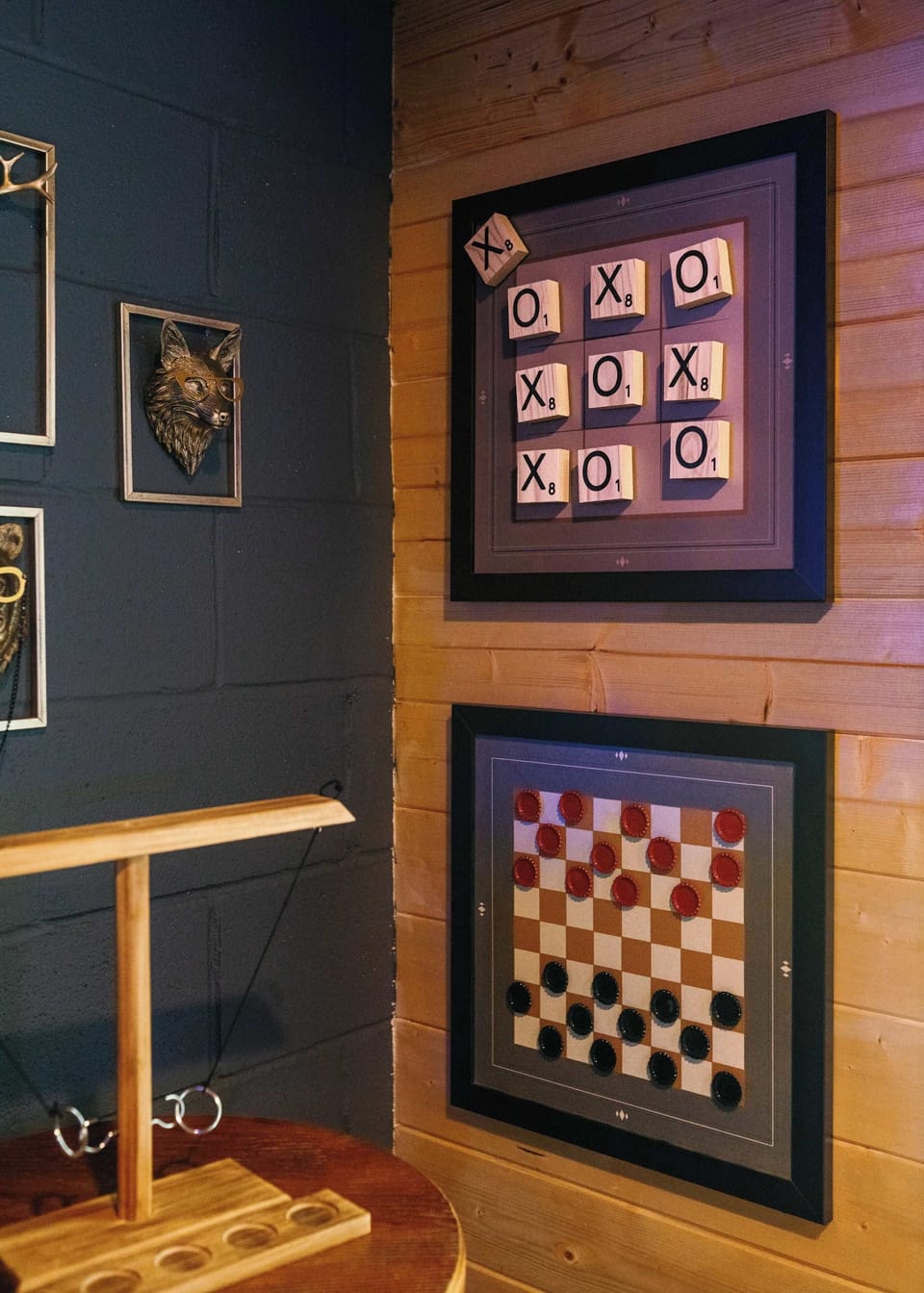 Unique decor meets interactive fun. Our rustic wood-paneled walls feature giant magnetic Tic-Tac-Toe and Checkers boards, plus a classic tabletop ring-toss game!