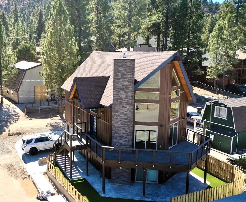 Newly constructed cabin with concrete parking for 4 cars and fenced yard.