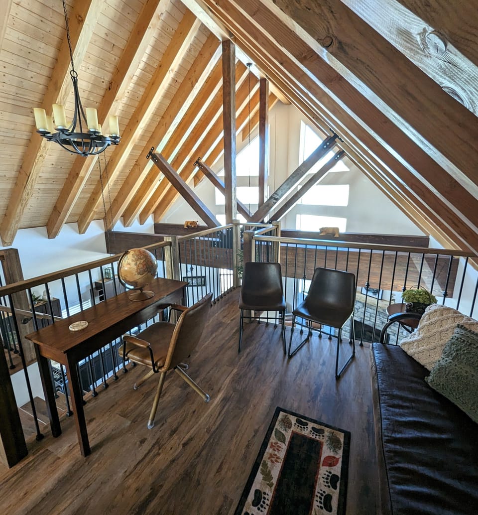 3rd floor loft with desk and futon overlooks the main living area of 2nd floor.