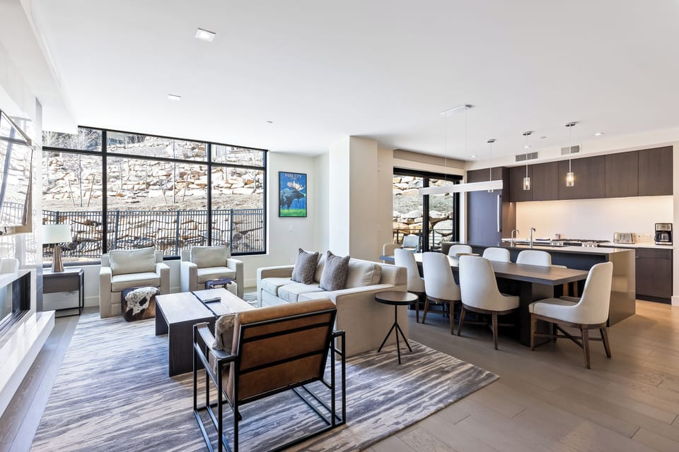 - Open concept living area with floor to ceiling windows and rocky hillside views
- Spacious layout blends cozy lounging, stylish dining and a fully stocked kitchen
- Ideal for game nights, shared meals or simply soaking in the serene surroundings