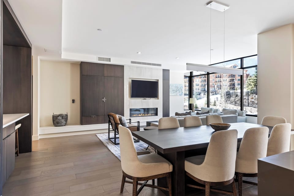 - Share laughter and meals around this spacious table with seating for eight
- Floor to ceiling windows brighten every corner with stunning mountain town light
- After dinner, cozy up by the fire or enjoy a movie night in style