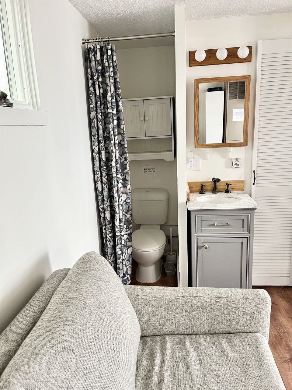 The toilet is separated from the rest of the cabin by a curtain and there is one sink for washing dishes and hands.