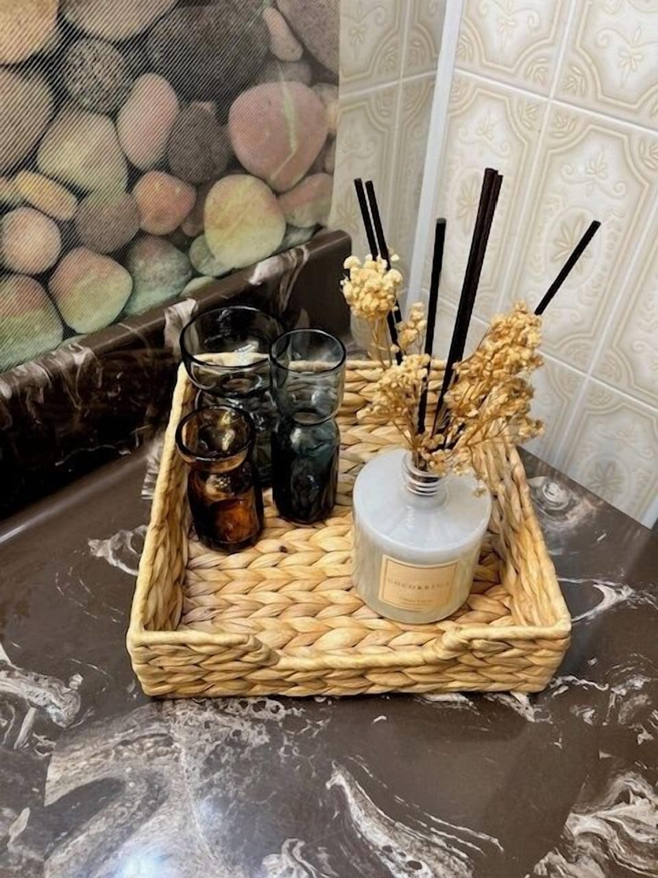Elegant and rustic home decor featuring a scented diffuser and decorative glasses, adding a touch of coziness and class to the cottage.