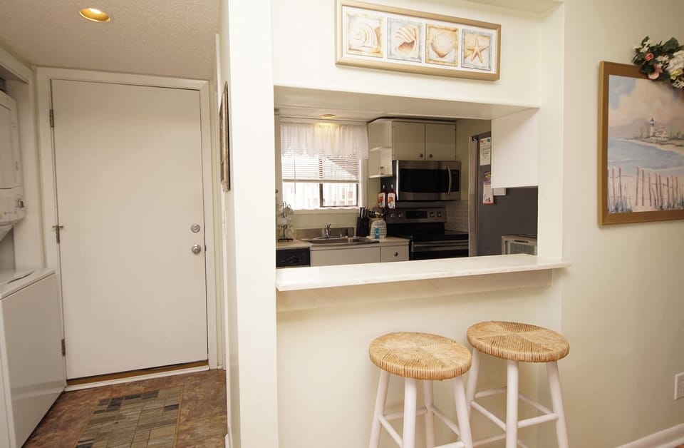 Your open kitchen flows seamlessly into the living space, with a convenient breakfast bar perfect for morning coffee or casual meals.