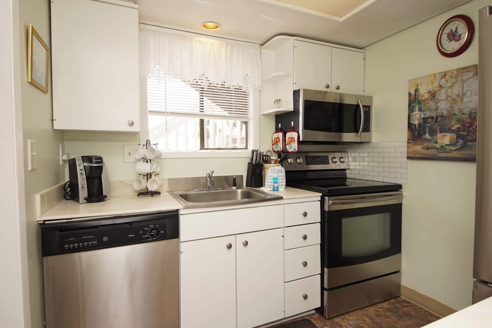 Your fully equipped kitchen awaits with modern appliances, bright natural light, and everything you need to prepare delicious meals during your stay.