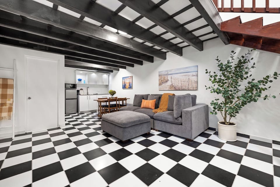 As you step into the first level of Villa Carolina, you're greeted by an inviting open floor plan encompassing a fully equipped kitchen, a 4-person dining area, and a living room .