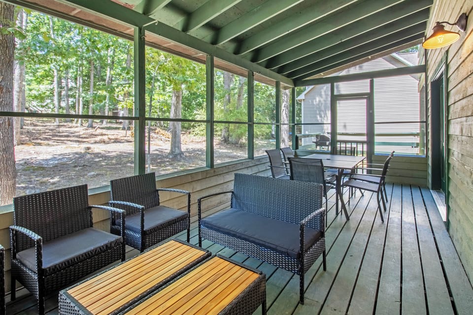 Screened porch with ample dining and lounge furniture