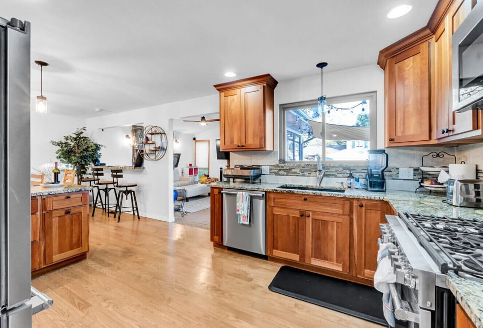 Kitchen, all Open to the Dining Room & Sunroom Room; Professional Grade Kitchen Stainless Appliances, View of Pool & Lake Arbor from Window.