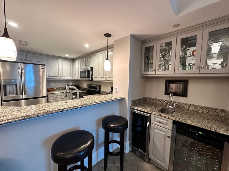 Modern kitchen with granite countertops and cozy breakfast bar seating