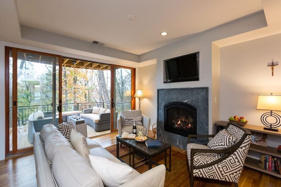 Living room opening to outer deck sitting and dining