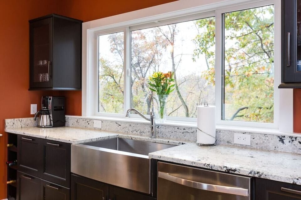 The kitchen sink with the a peaceful view of the river and the trees.