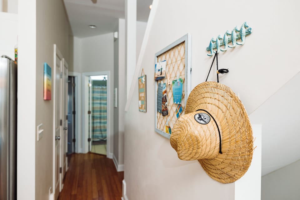 Your beach-themed hallway welcomes you with coastal charm—grab your hat from the convenient hooks and explore your seaside retreat.