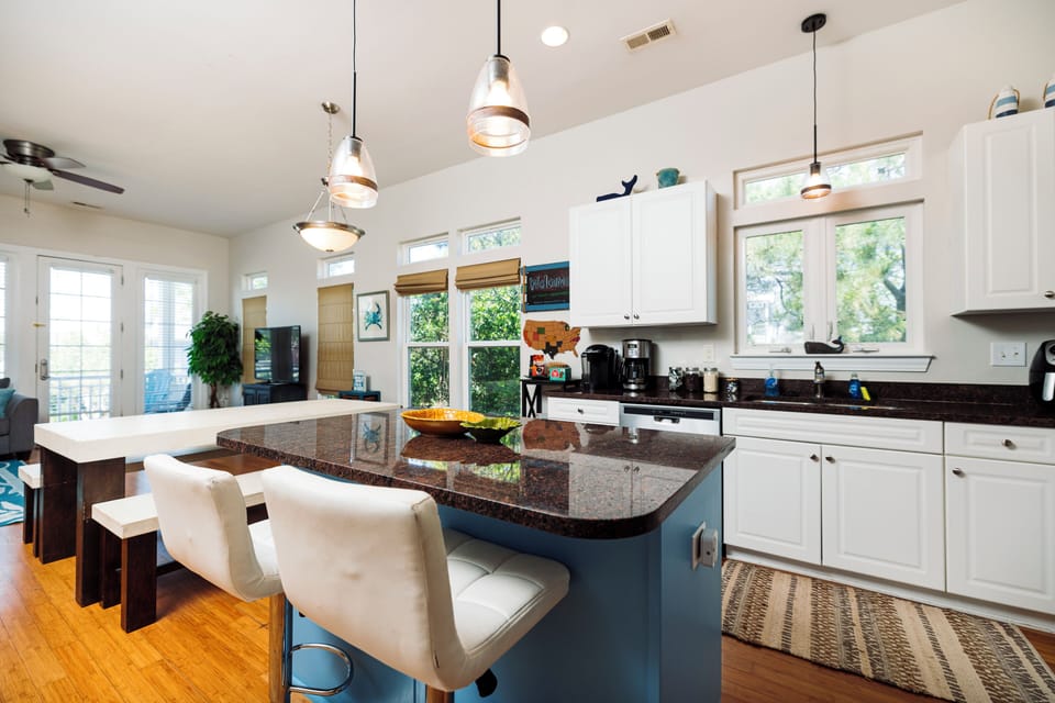 Cook memorable meals in your spacious kitchen featuring granite counters, modern appliances, and bar seating for casual dining.