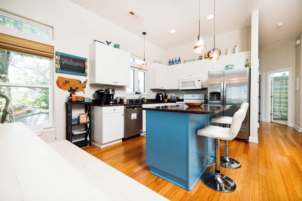 Your fully equipped kitchen features modern appliances, a welcoming island with bar seating, and everything you need to create memorable meals during your stay.