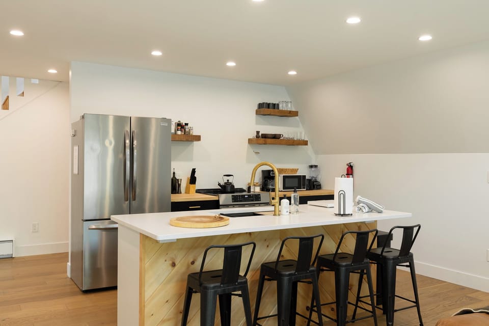 The view of the kitchen at a glance, complete with seating for four at the island. 