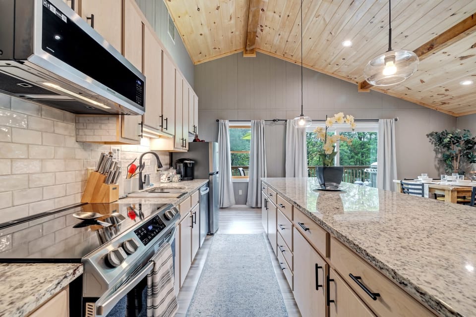 Kitchen: Bright and airy space with sleek finishes and spacious island for culinary adventures!