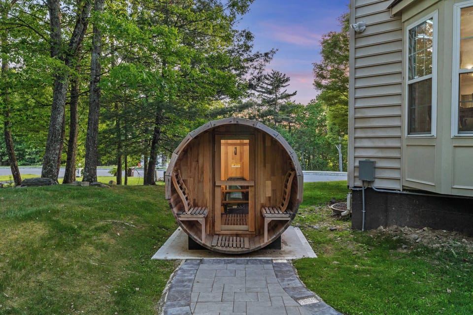 Sweat it out in the barrel sauna — the stone path stays lit just enough to find your way back for another soak.