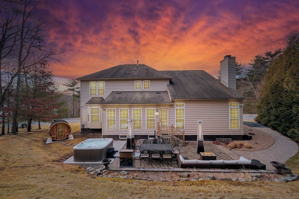 Watch the sky go pink over the fire pit heaters while the hot tub and barrel sauna wait their turn — this is where the night slows all the way down.