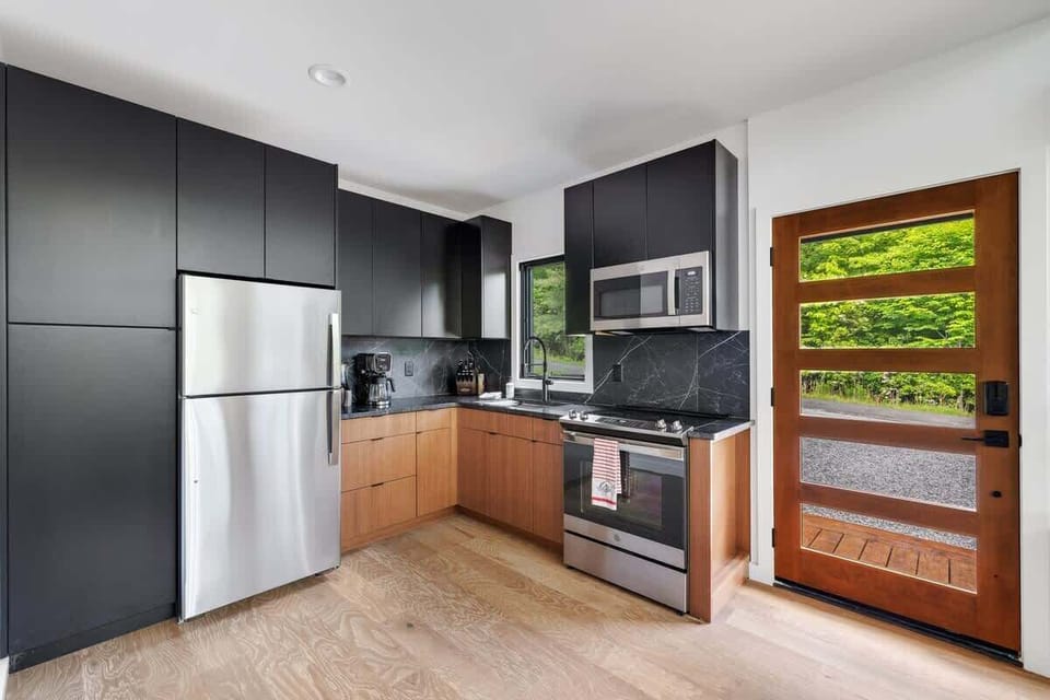 Minimalist in style, but fully equipped in function, this kitchen features sleek appliances, quality cookware, and everything needed for elevated meals in. 