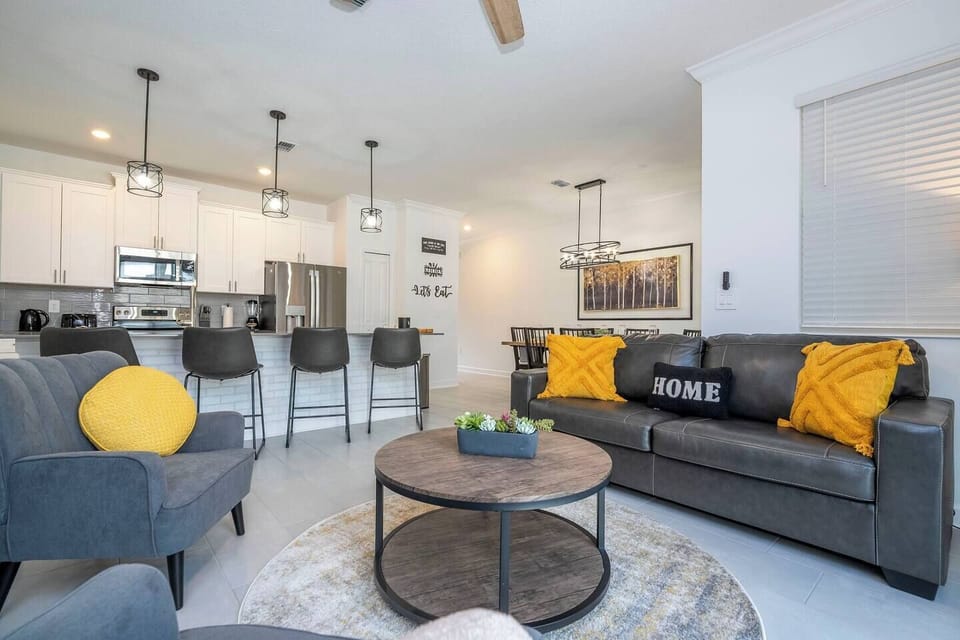 Step into this spacious, comfortable living area. The expansive room is adorned with tasteful decor, offering a blend of modern aesthetics and homey warmth. 