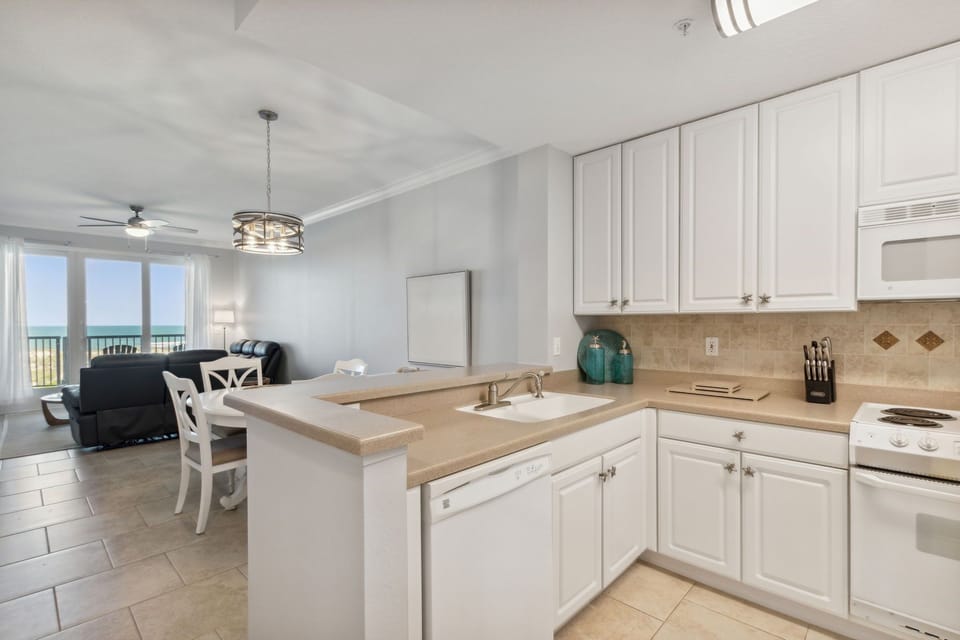 Fully Stocked Kitchen Opens to Living and Dining Areas