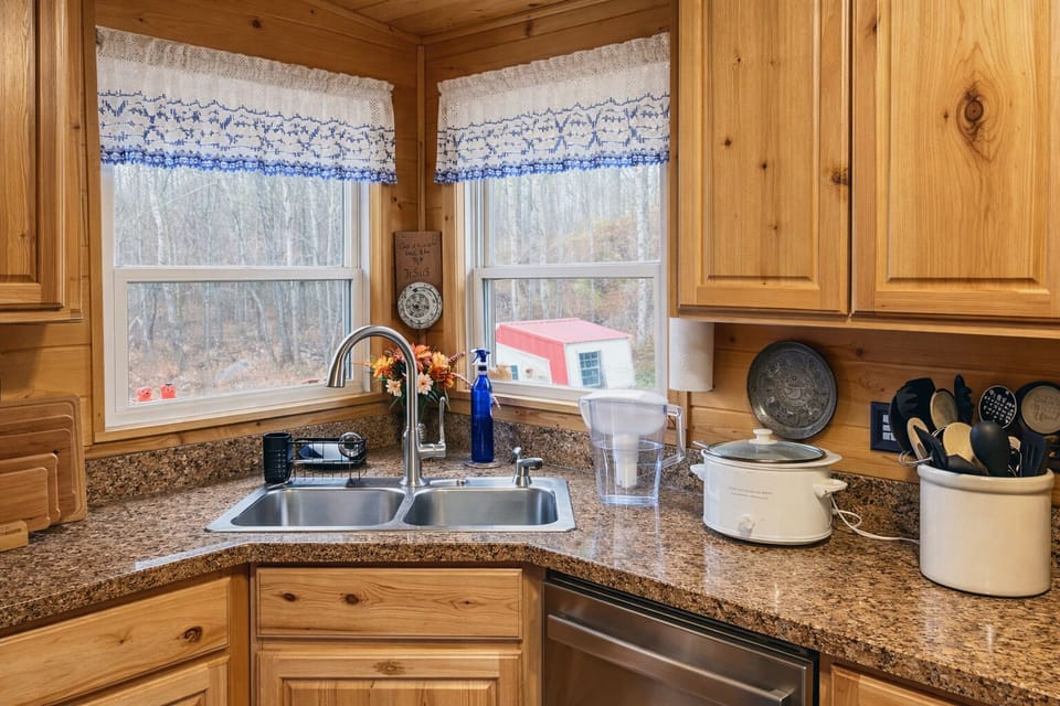 bottom cabinet left of sink-air fryer griddle 3 crock pots mixer blender etc.