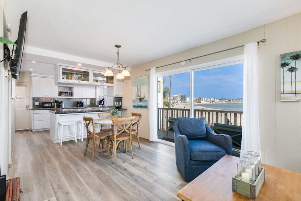 Modern kitchen meets cozy lounge with stunning beach views.