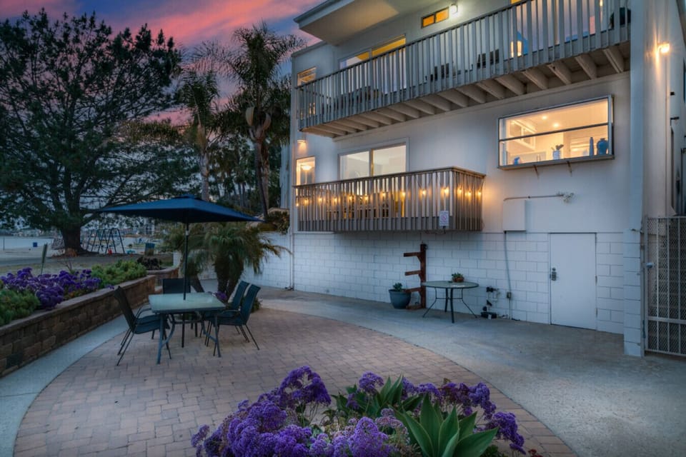 Enjoy serene evening meals or morning coffee in this beautifully arranged patio area, offering breathtaking sunset views over the beach.